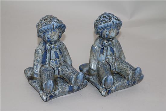 A pair of Clarice Cliff golly blue mottle glazed bookends, height 15.5cm, one damaged